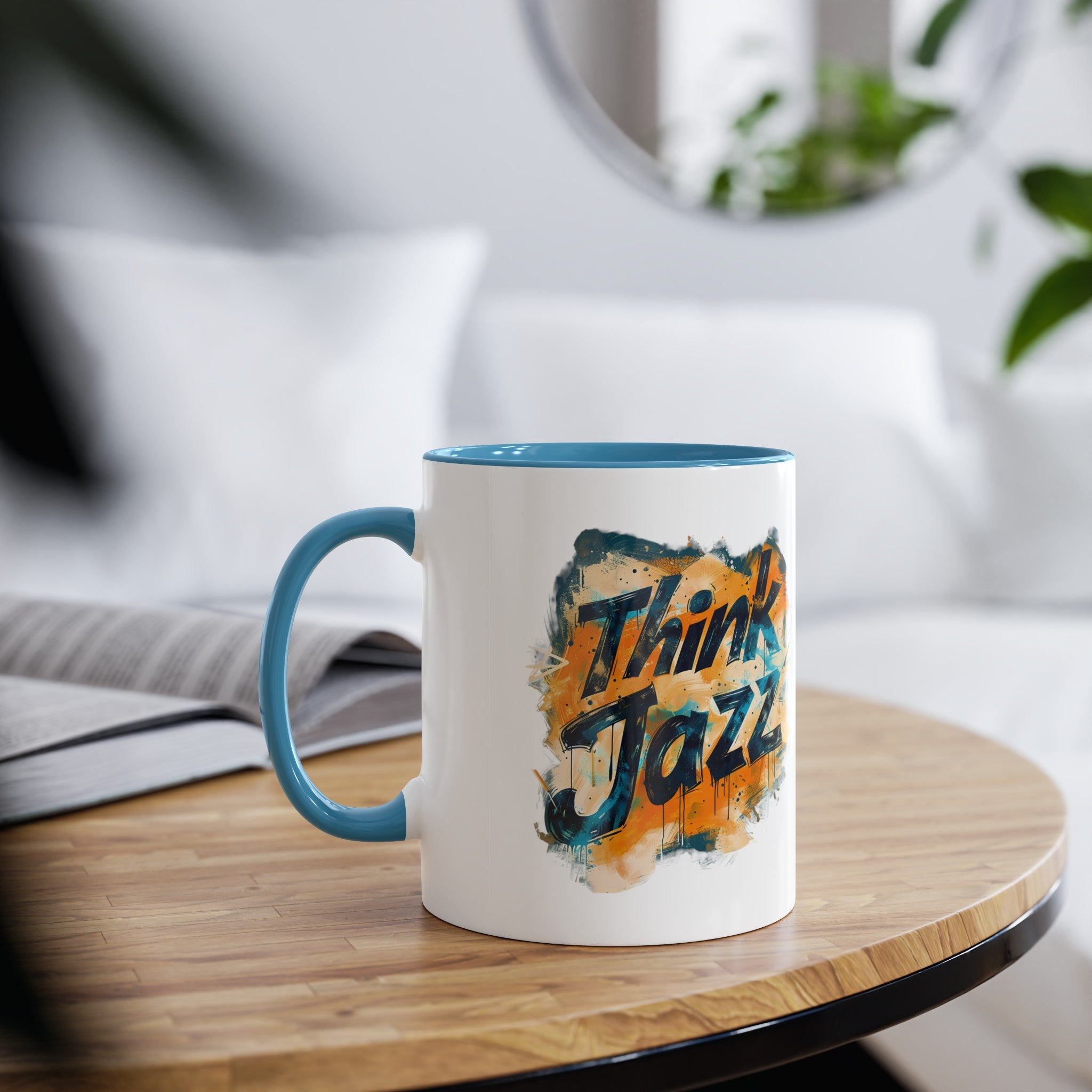A white coffee mug with a blue interior the abstract blue and gold image says ‘Think Jazz’