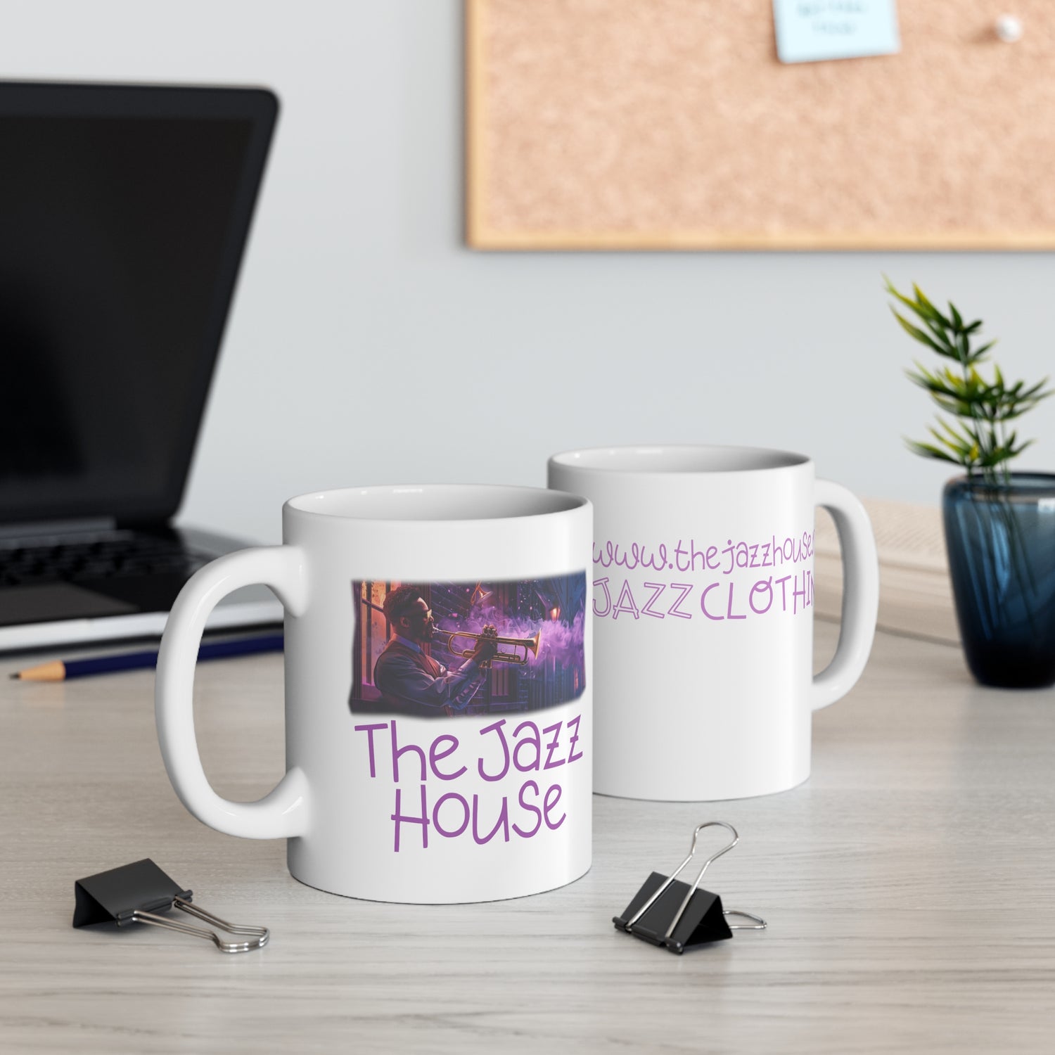 A coffee mug featuring ‘The Jazz House’ logo image of a trumpeter leaning against the wall of The Jazz House club playing, whilst purple smoke rises from his instrument. The scene is set in a dimly lit alley. The rear of the mug has the website URL with the words ‘Jazz Clothing.’